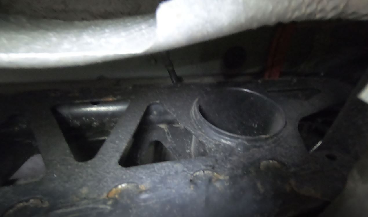 Disconnect the ground strap from the body (near rear bushing)