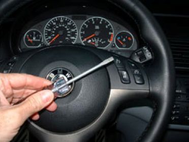 Depress steering wheel retainers